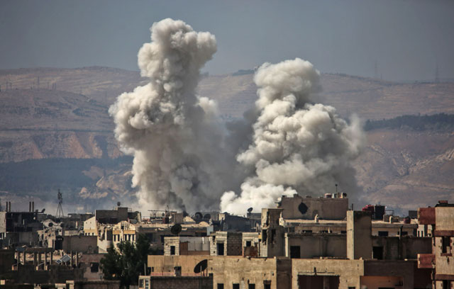 Smoke billows following bombardment on Friday, in a rebel-held town, on the outskirts of the capital Damascus (AFP photo)