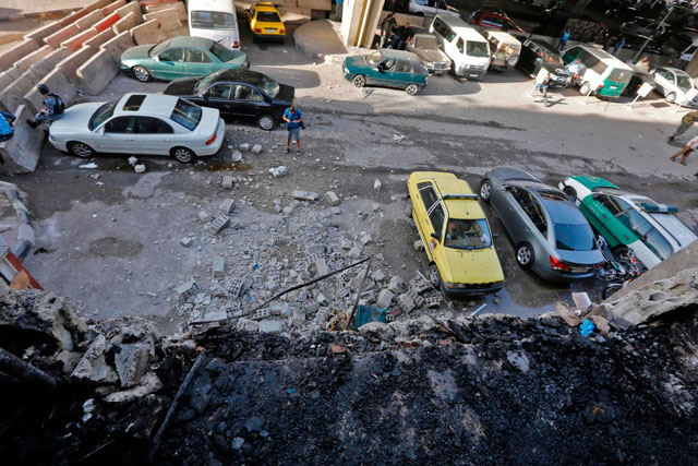 This photo shows the site of a double suicide bomb attack which hit Al Midan police station in Syria’s capital Damascus, on Monday  (AFP photo)