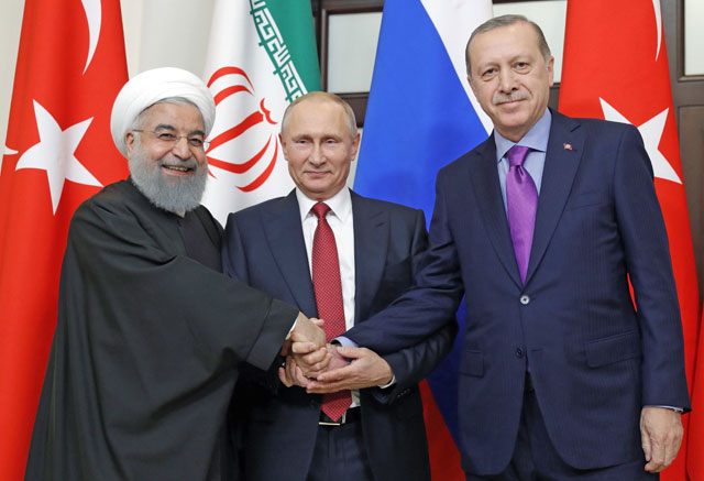 Russian President Vladimir Putin (centre), Turkish President Recep Tayyip Erdogan (right) and Iranian President Hassan Rouhani pose during a trilateral meeting on Syria in Sochi on Wednesday (AFP photo)