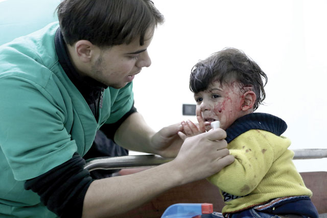 A wounded child waits to get treatment at a hospital after Assad regime’s warplane carried out air strikes over Arbin town of the Eastern Ghouta region in Damascus, Syria, on November 27 (Anadolu Agency photo)