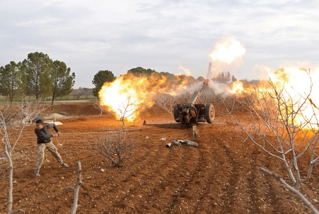 An opposition fighter fires a missile from a village near Al Tabanah during ongoing battles with government forces in Syria’s Idlib province on Thursday (AFP photo)