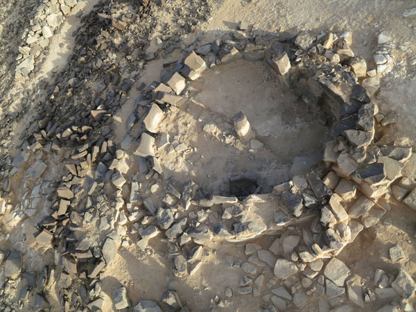 Excavated Late Neolithic building with standing pillars, on slope of Mesa 7, at Wadi Al Qattafi (Photo courtesy of Yorke Rowan and Eastern Badia Archaeological Project)