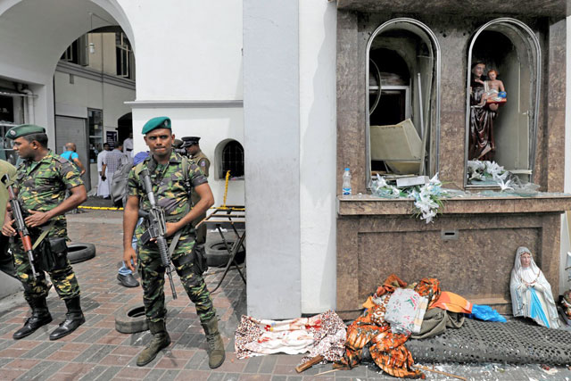Sri Lankan military officers guard St Anthony’s Shrine in Colombo, on April 21 (Reuters photo)