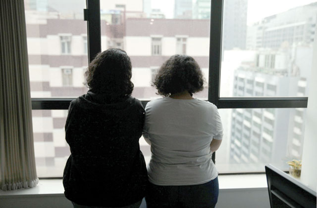 Sisters from Saudi Arabia, who go by aliases Reem and Rawan, are photographed at their lawyer Michael Vidler's office in Hong Kong, China, on Saturday (Reuters photo)