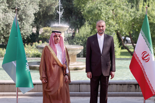 Iranian Foreign Minister Hossein Amir Abdollahian poses for photo with his Saudi counterpart Faisal Bin Farhan in Tehran, on Saturday (AFP photo)