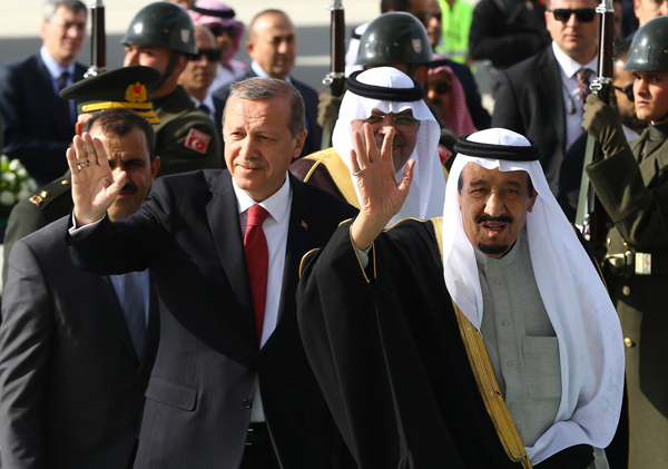 Turkey’s President Recep Tayyip Erdogan (left) and Saudi King Salman Bin Abdulaziz Al Saud wave to the crowd at Esenboga Airport in Ankara on April 11 (AFP photo)