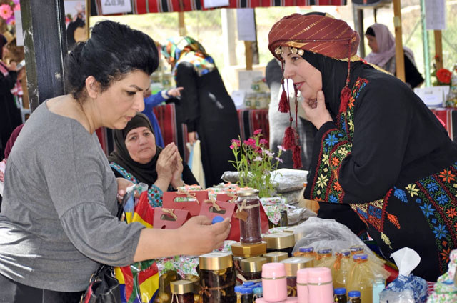   A woman browses a stall during Jerash’s Labaneh Festival on Friday (Photo By Ahmed Bani Mustafa)