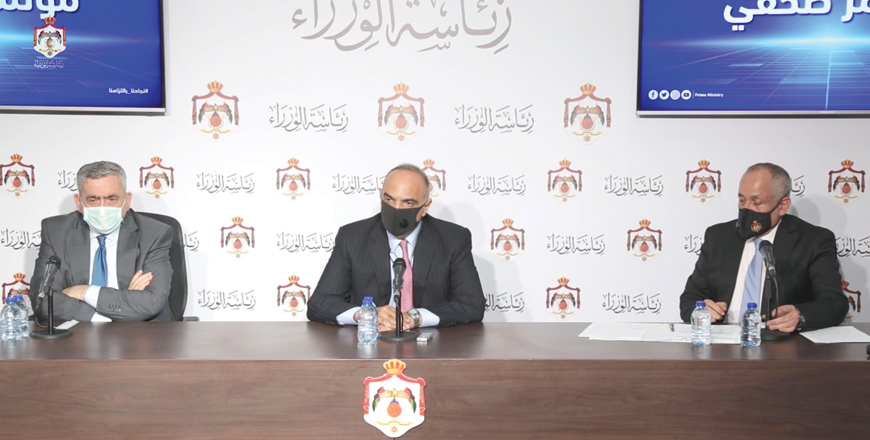 In this image grab taken from a video posted on the Prime Ministry’s Facebook page, Prime Minister Bisher Al Khasawneh is seen briefing the media at the Prime Ministry on Wednesday, accompanied by Health Minister Nathir Obeidat and Minister of State for Media Affairs Ali Al Ayed 