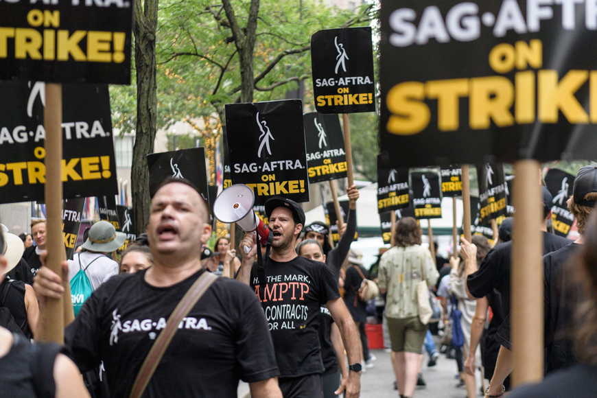 AG-AFTRA members and supporters walk the picket line as members of the Screen Actors Guild strike in New York on July 19 (AFP photo)