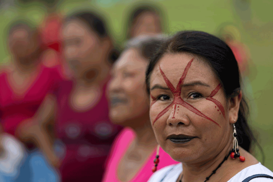 A Siekopai indigenous woman with a traditional paint design on her face poses for a photo during the second binational meeting of the Siekopai Nation community in the Amazon region in Lagartococha, Peru, on January 10 (AFP photo by Pedro Pardo)