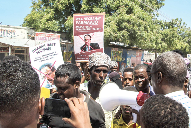 People hold posters of Somalia's President Mohamed Abdullahi Mohamed during the protest against him in Mogadishu, Somalia, on Saturday (AFP photo)