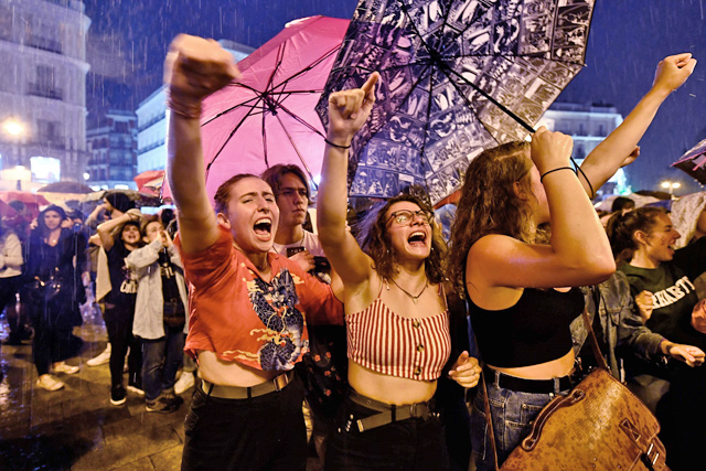Women protest in the rain at the Puerta del Sol square during a demonstration under the motto ‘Feminist Emergency’ against gender violence in Madrid, organised by several women's groups across the country, on Friday (AFP photo)