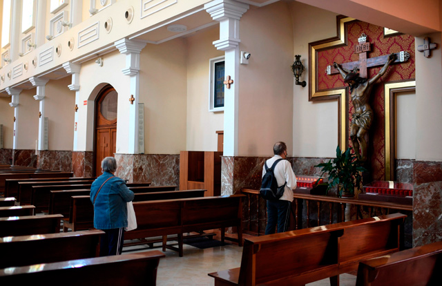 People pray at San Vicente de Paul parish in Madrid, on Monday (AFP photo)