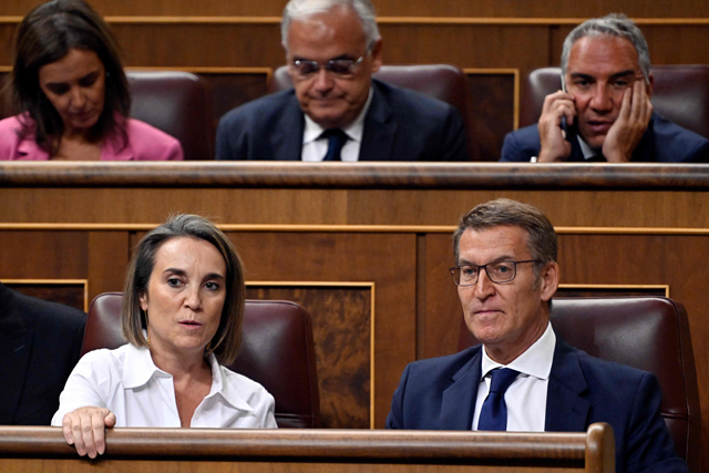 Leader of the opposition Partido Popular - PP (People’s Party) and candidate for prime minister, Alberto Nunez Feijoo (bottom right) and PP spokesperson Cuca Gamarra (bottom left), attend the first session of a parliamentary debate to vote through a prime minister at Las Cortes in Madrid on Tuesday (AFP photo)
