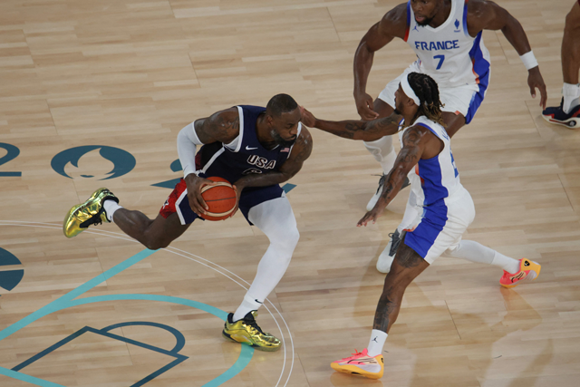 USA's #06 LeBron James fights for the ball with France's #01 Frank Ntilikina in the men's Gold Medal basketball match between France and USA during the Paris 2024 Olympic Games at the Bercy Arena in Paris on Saturday (AFP photo)