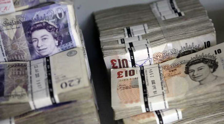 Wads of British Pound Sterling banknotes are stacked in piles at the GSA Austria (Money Service Austria) company’s headquarters in Vienna on July 22, 2013  (Reuters file photo)    