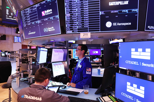 Traders work on the floor of the New York Stock Exchange during morning trading on Friday in New York City (AFP photo)