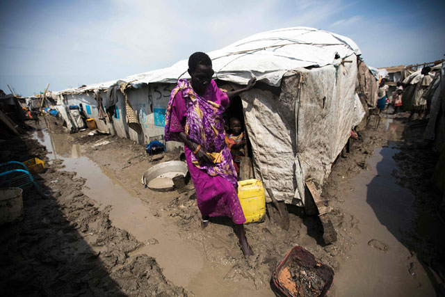 A woman walks outside her shelter in the Protection of Civilians site in Malakal, on Monday (AFP photo)
