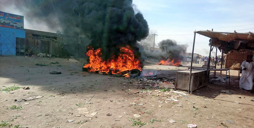 A bonfire is lit along the street during protests against price increases in Atbara, Nile River state, in north-eastern Sudan, on Thursday (Reuters photo)