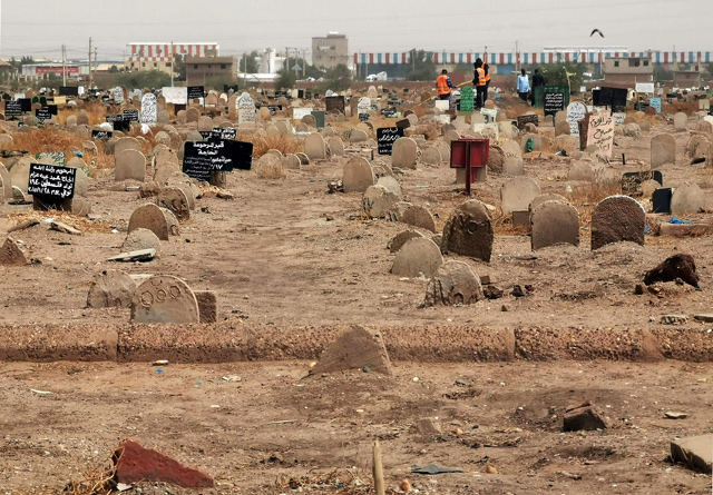 This photo taken on Saturday shows members of a forensic team at a cemetary, in the Sahafa neighbourhood, south of the Sudanese capital Khartoum  (AFP photo)
