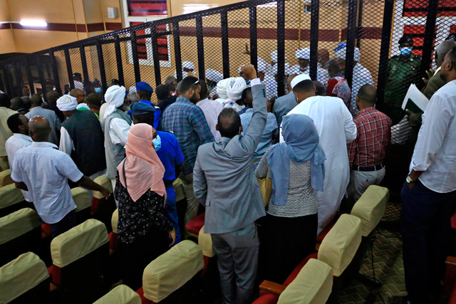 People cheer inside the courtroom during the trial of Sudan’s ousted president Omar Al Bashir along with 27 co-accused, over the 1989 military coup that brought Bashir to power, during a session at a courthouse in the Sudanese capital Khartoum on Tuesday (AFP photo)