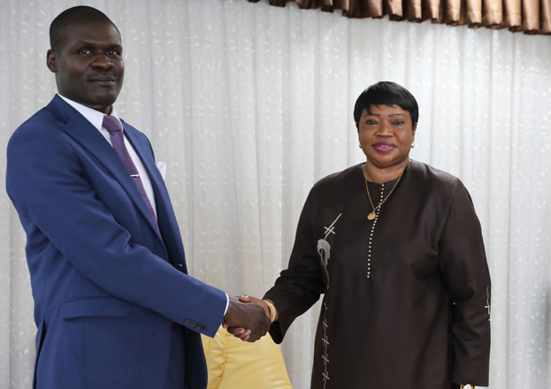 Sudan’s Minister of Justice Nasruddin Abdel Bari (left) shakes hands with the International Criminal Court Prosecutor Fatou Bensouda during her visit to the capital Khartoum on Sunday  (AFP photo)