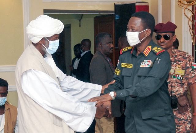 Member of Sudan’s sovereign council Shams Al Din Kabashi (right) meets with head of the Supreme Council of Beja Prefectures and Independent Umudiyyahs Muhammad Al Amin Turk, upon arrival with a delegation to the city of Port Sudan, on Sunday (AFP photo)