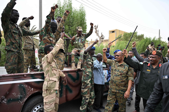 The governor of Sudan's Red Sea State Mustafa Mahmud (second right), salutes troops in Port Sudan in the war-torn country on Wednesday (AFP photo)