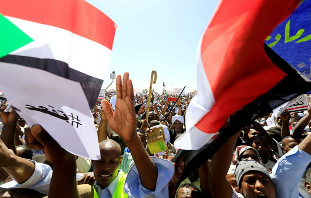 Supporters of Sudan’s President Omar Al Bashir wave their national flags as they chant slogans to his favour during a rally at the Green Square in Khartoum, Sudan, on January 9 (Reuters photo)