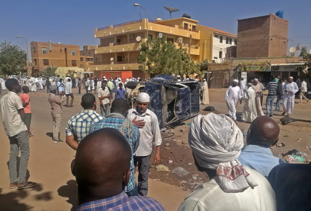 Sudanese men take part in an anti-government protest in the capital Khartoum on Friday  (AFP photo)