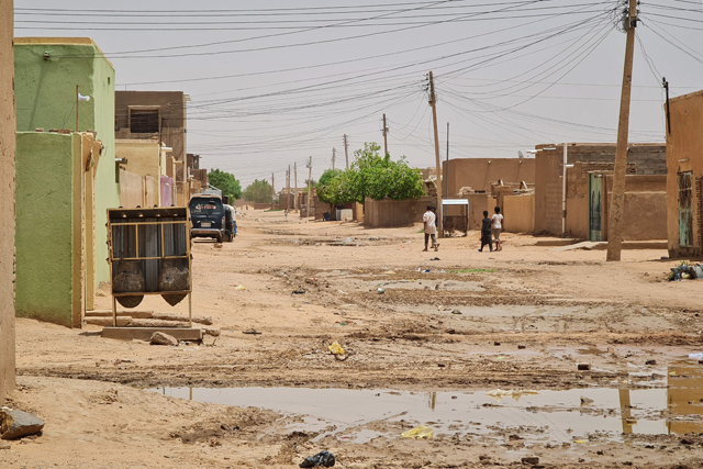 A few people walk on a street as fighting continues in Khartoum on Tuesday (AFP photo)