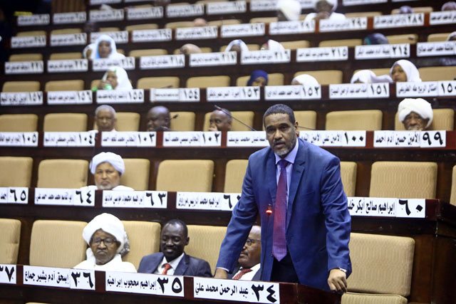 A Sudanese parliament member speaks during a National Assembly emergency session discussing a state of emergency declared by the president following anti-government protests, on Monday (AFP photo)