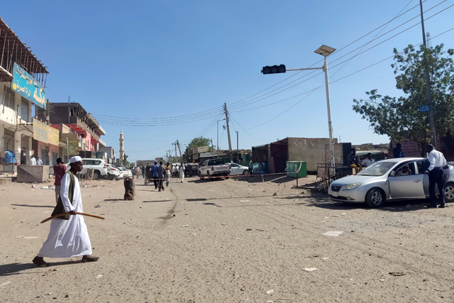 Sudanese civilians walk through an empty road with most shops closed for security reasons in Gedaref city in eastern Sudan on Wednesday (AFP photo)