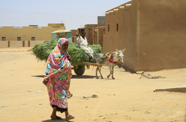 A woman walks in the village of deposed Sudanese president OmarAl Bashir, Hosh Bannaga, some 170 kilometres north of the capital Khartoum, on Sunday  (AFP photo)