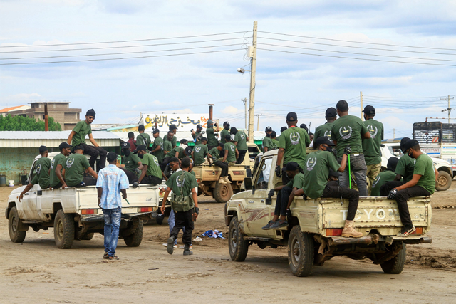Members of a 'joint security cell' made up of various military and security services affiliated with Sudan's army, ride in the back of trucks as they take part in a parade in Gedaref city in the east of the war-torn country, on Sunday (AFP photo)
