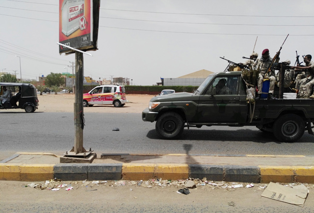 Sudanese security forces drive through a main road linking Omdurman with its twin city Khartoum on the first day of a civil disobedience campaign across Sudan on Sunday (AFP photo)