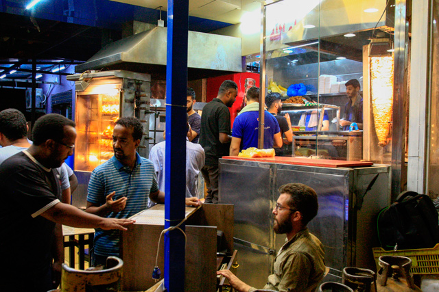 Customers wait for their sandwiches at a Syrian restaurant in the Kafouri neighbourhood of the Sudanese capital Khartoum on July 31 (AFP photo)