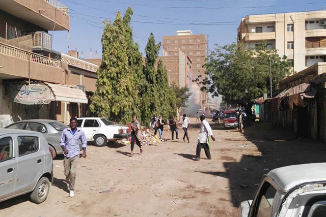 Protesters run away from tear gas smokes during a demonstration in Khartoum, Sudan, on Monday (AFP photo)