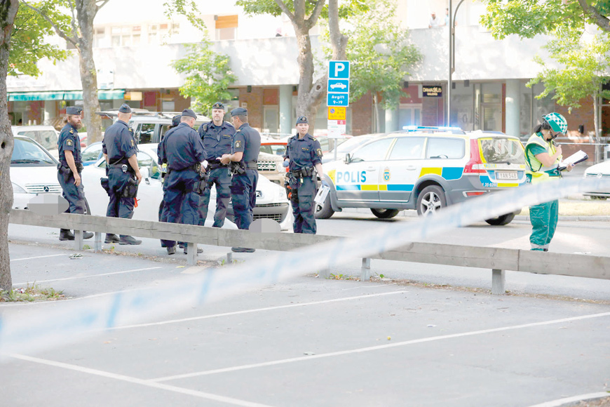 This photo dated on June 30 shows police at the scene where two young men were shot in Sollentuna, north of Stockholm, Sweden (AFP photo)