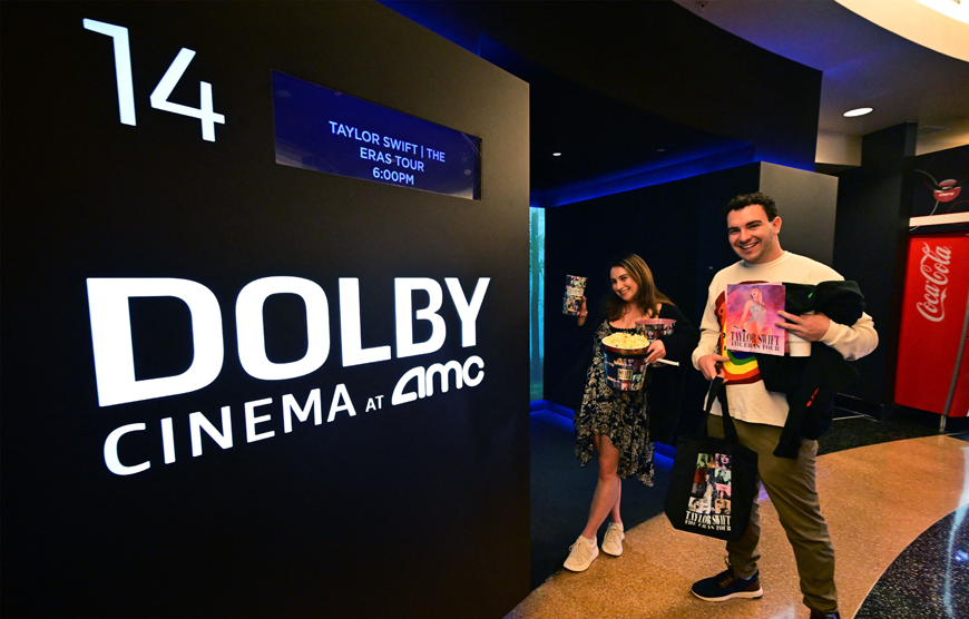 US singer Taylor Swift’s fans Kasey Longstreet and Alex Dombrower (right) pose with their merchandise as they attend the ‘Taylor Swift: The Eras Tour’ concert movie world premiere at AMC Century City theatre in Century City, California, on Thursday (AFP photo)