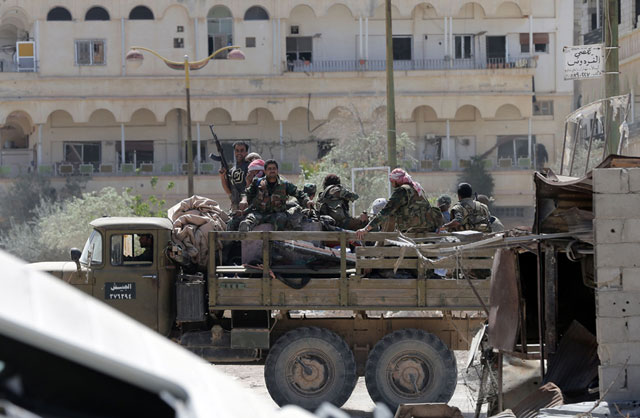 Syrian soldiers patrol in the town of Al Qaryatain, in the province of Homs in central Syria, on Monday after Syrian troops regained control of the town from Daesh militants the previous day (AFP photo)