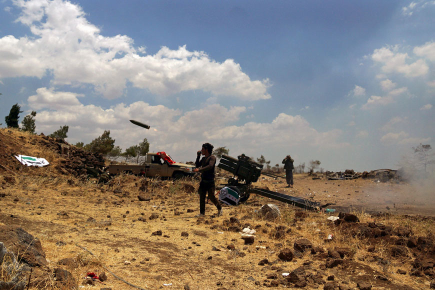 Free Syrian Army fighters fire rockets towards forces loyal to Syria’s President Bashar Assad in the northern countryside of Quneitra, Syria, on Wednesday (Reuters photo)