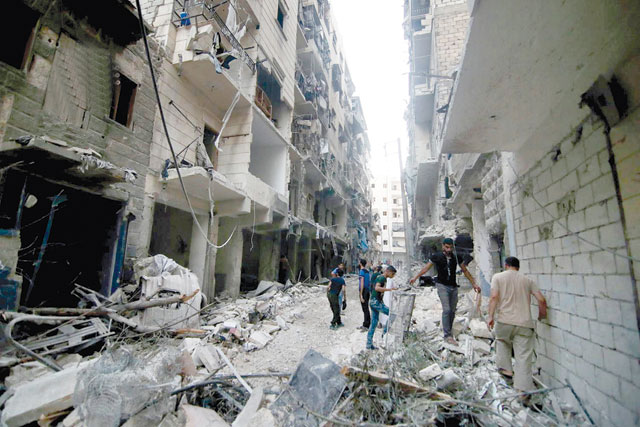 This July 29, 2016 file photo, provided by the Syrian anti-government activist group Aleppo Media Centre, shows Syrian citizens inspect damaged buildings after air strikes hit  Aleppo, Syria (AP photo)