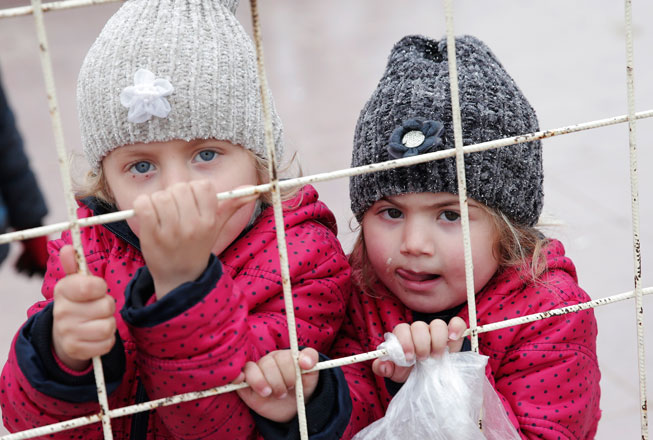 Syrian children wait to return to their country at the Turkish border crossing with Syria on the outskirts of Kilis, southeastern Turkey, on Thursday (AP photo)