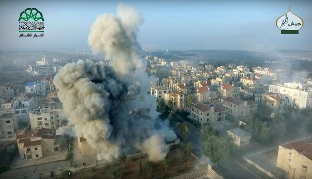 This still image taken from drone footage, posted online by the communications arm of Ahrar Al Sham militant group, purports to show a blast on the ground, apparently the result of an air strike, in a Syrian-government controlled neighbourhood of Aleppo, Syria (Ahrar Al Sham, militant video, via AP)