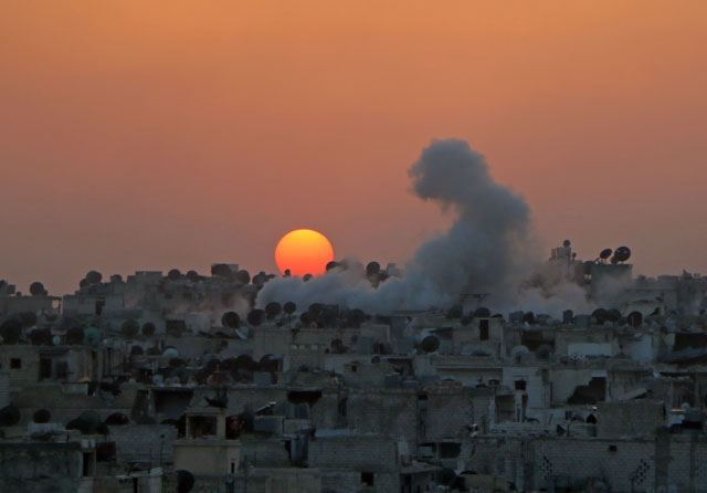 Smoke rises after Syrian rebel forces reportedly attacked the headquarters of regime forces with bomb-laden vehicles in Aleppo, Syria, on Saturday (Anadolu Agency photo)