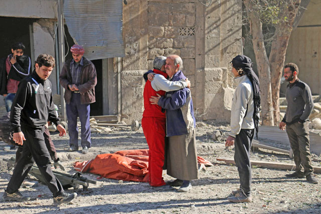 Syrians comfort each other on Saturday following a reported air strike on Aleppo’s rebel-held neighbourhood of Bab Al Nayrab.   Intense government air strikes and artillery fire killed at least 27 people in rebel-held parts of Syria’s Aleppo, where hospitals have been destroyed and schools forced to close (AFP photo)