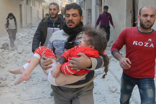 A wounded child is taken to hospital after warplanes reportedly belonging to the Syrian army carried out air strikes over residential areas in Aleppo on Tuesday (Anadolu Agency photo)