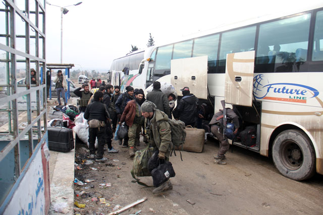 Syrian rebel fighters arrive in the opposition-controlled Khan Al Assal region, west of Aleppo after being evacuated from the embattled city, on Thursday (AFP photo)