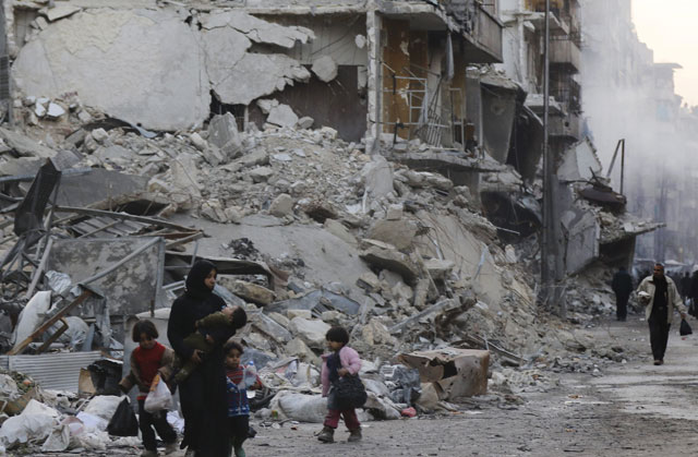 Syrians walk amid destroyed buildings as residents return to Aleppo’s formerly rebel-held Al Shaar neighbourhood on Saturday, a month after government forces retook the northern Syrian city from rebel fighters (AFP photo)